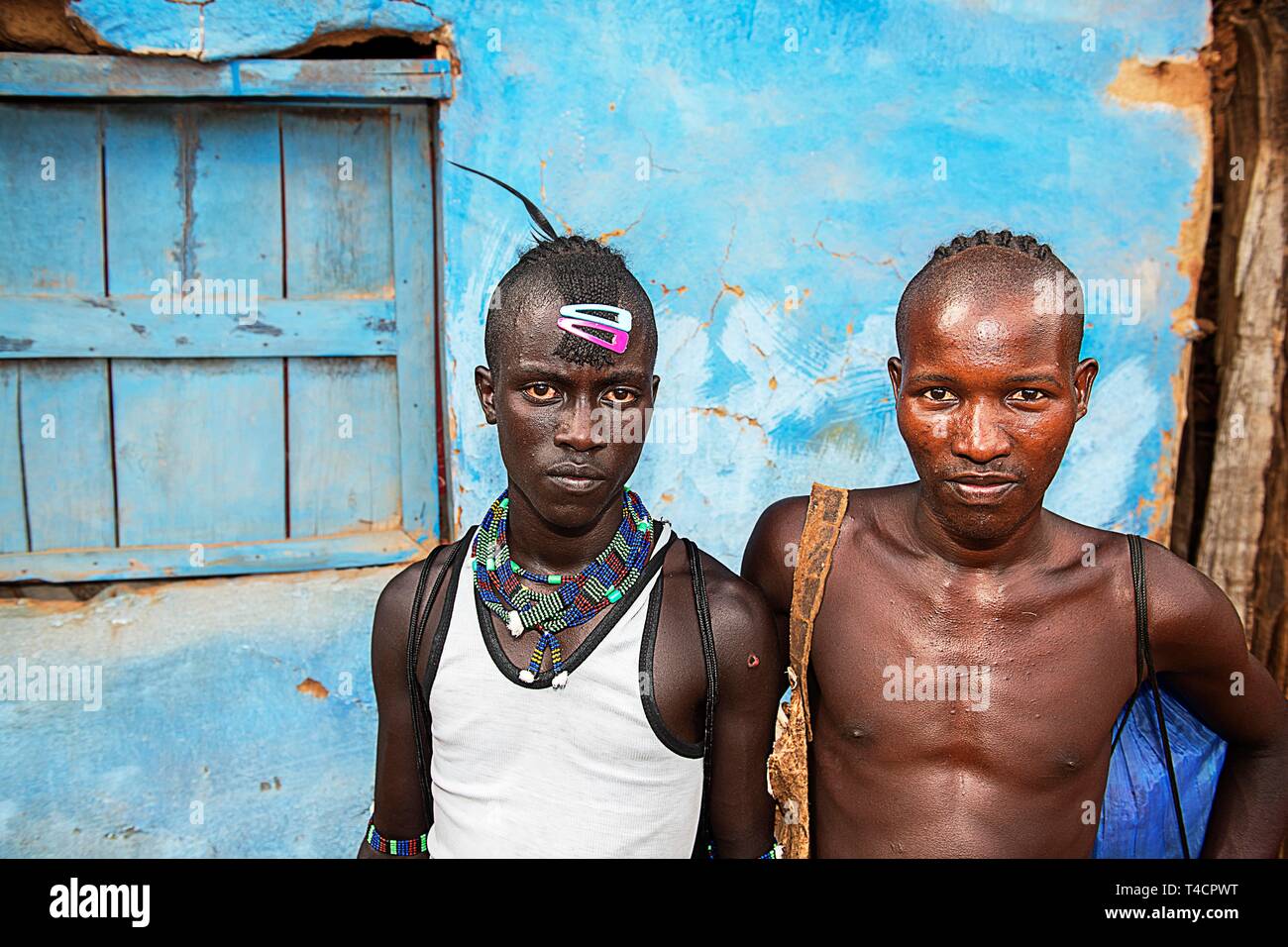 Young men of the Hamer ethnic group with colourful hair clips and pearl jewellery, Dimeka, Lower Omo Valley, Omo region, South Ethiopia, Ethiopia Stock Photo