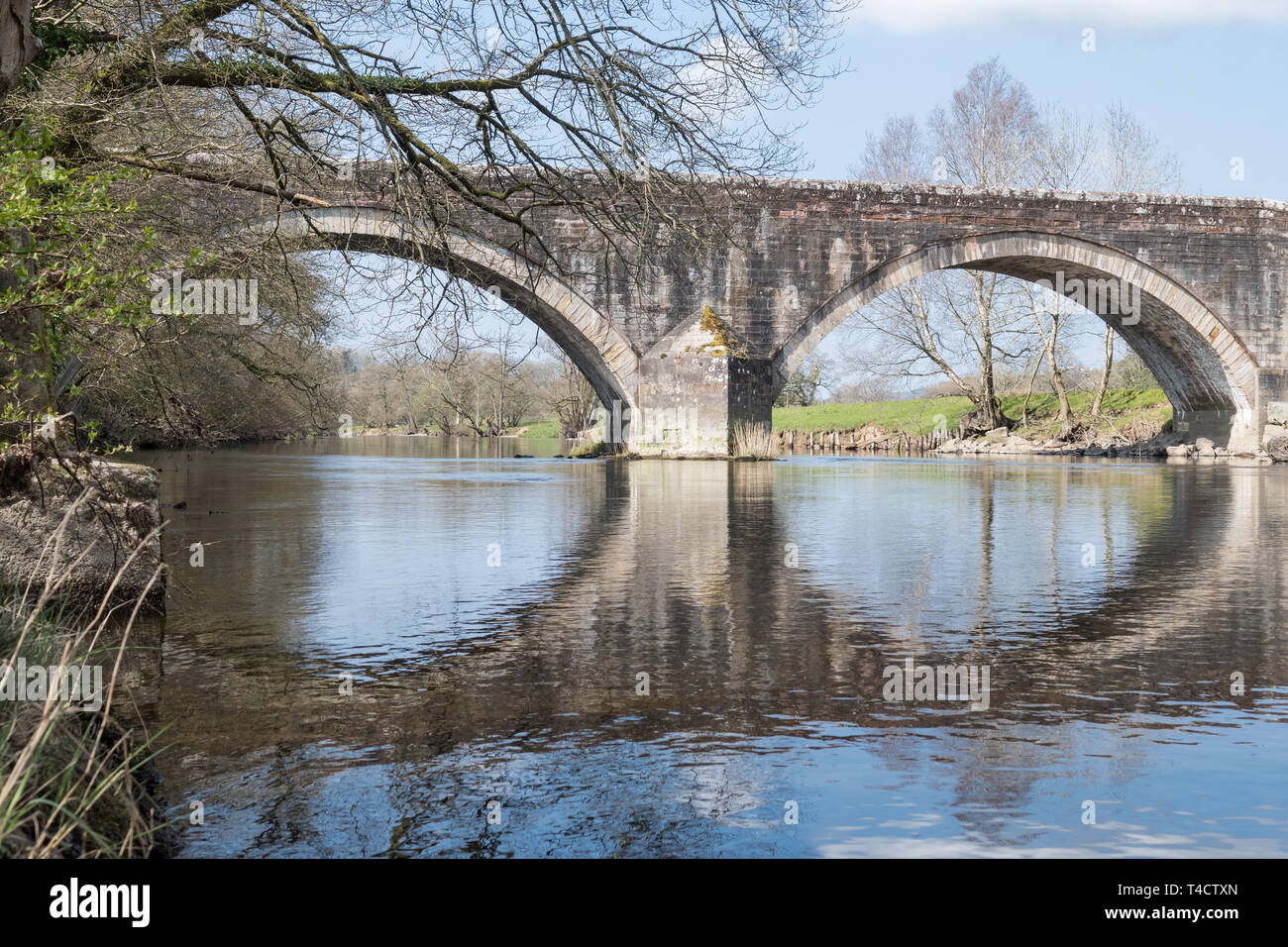 Ouse Bridge over the River Derwent at the outlet of Bassenthwaite Lake, Dubwath, Cumbria, England, UK Stock Photo