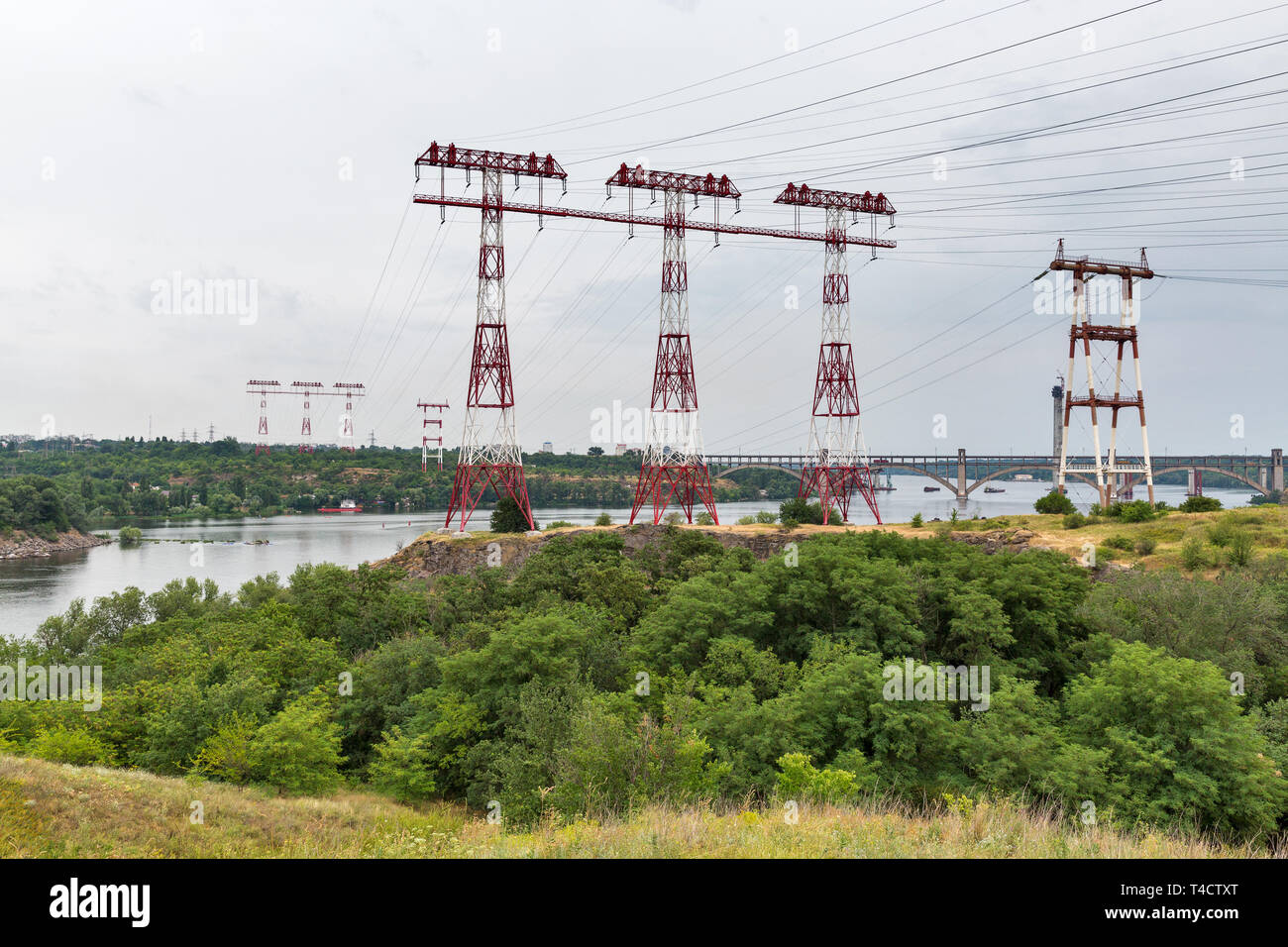 High voltage power lines towers on island of Khortytsia and Dnieper river in Ukraine. Stock Photo