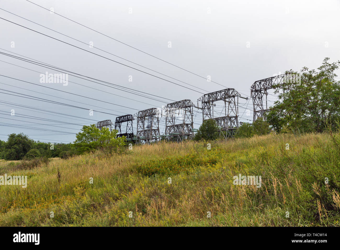 High voltage power lines towers on island of Khortytsia in Ukraine. Stock Photo