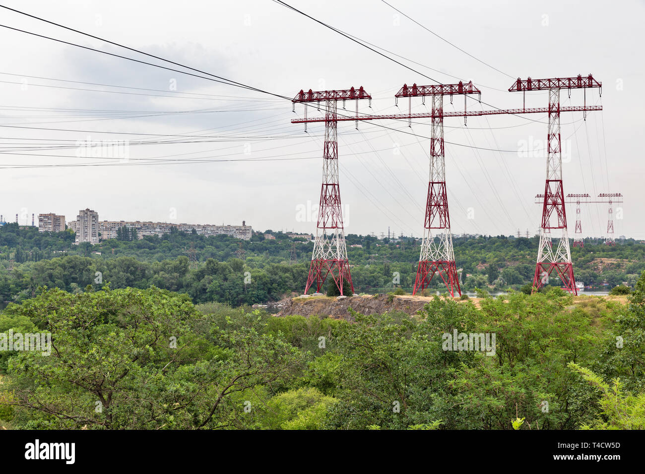 High voltage power lines towers on island of Khortytsia and Dnieper river in Ukraine. Stock Photo