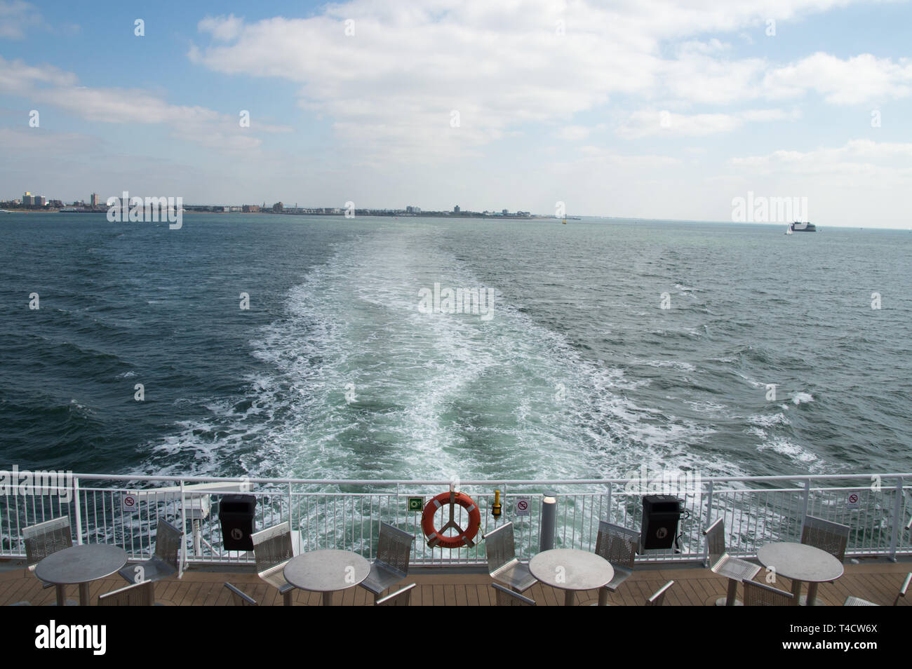 Water trails on Sea at the back of a passenger ferry covering holiday destination Stock Photo
