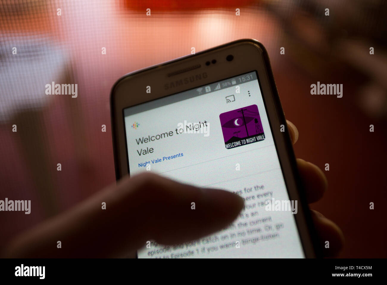 A smartphone with ‘Welcome to Night Vale’ podcast playing, indoors Stock Photo