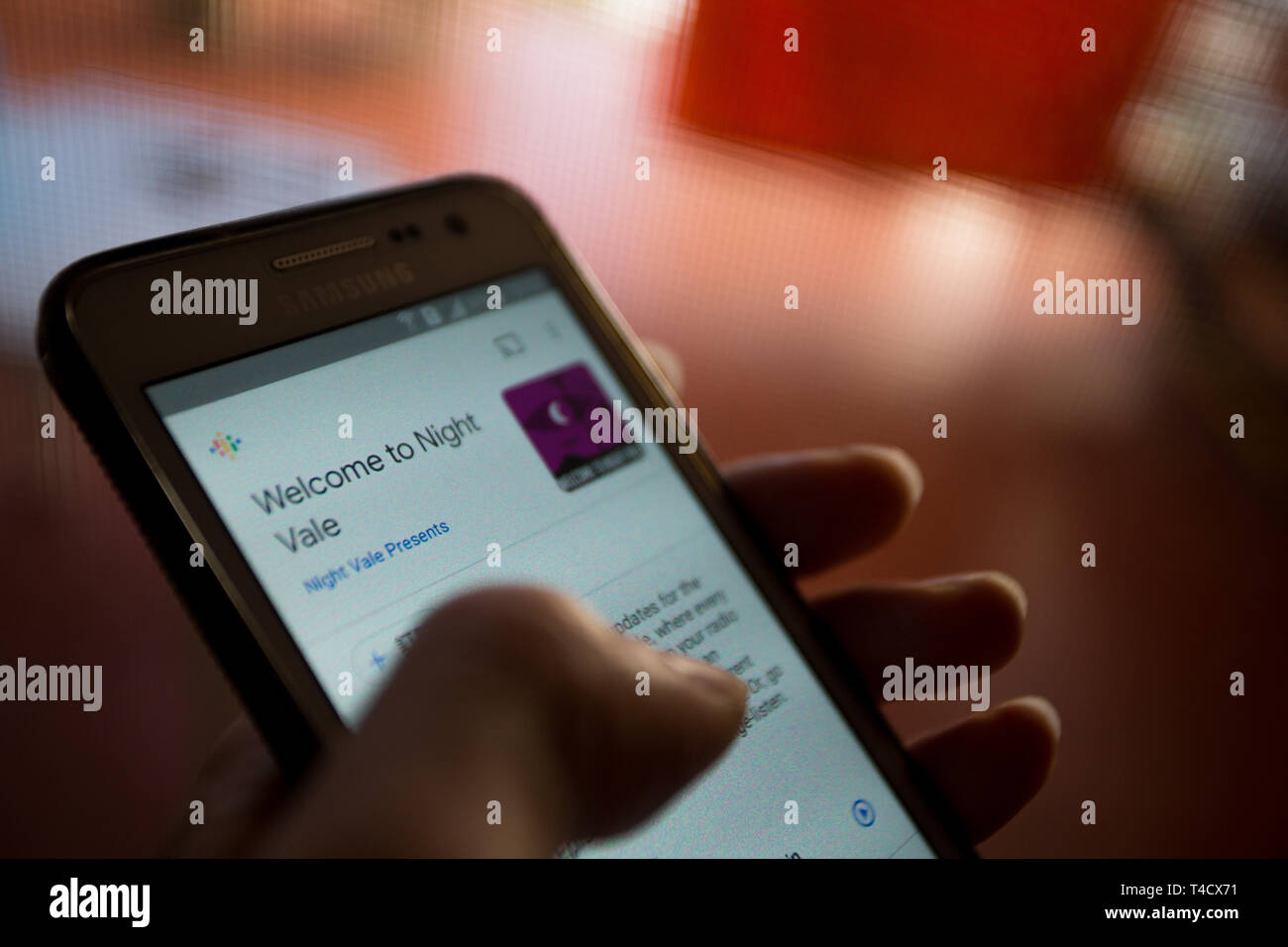 A smartphone with ‘Welcome to Night Vale’ podcast playing, indoors Stock Photo