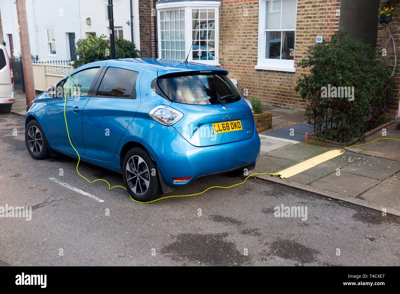 Renault Zoe electric car vehicle with batteries being charged up using an  electrical cable from a domestic house. UK. (106 Stock Photo - Alamy