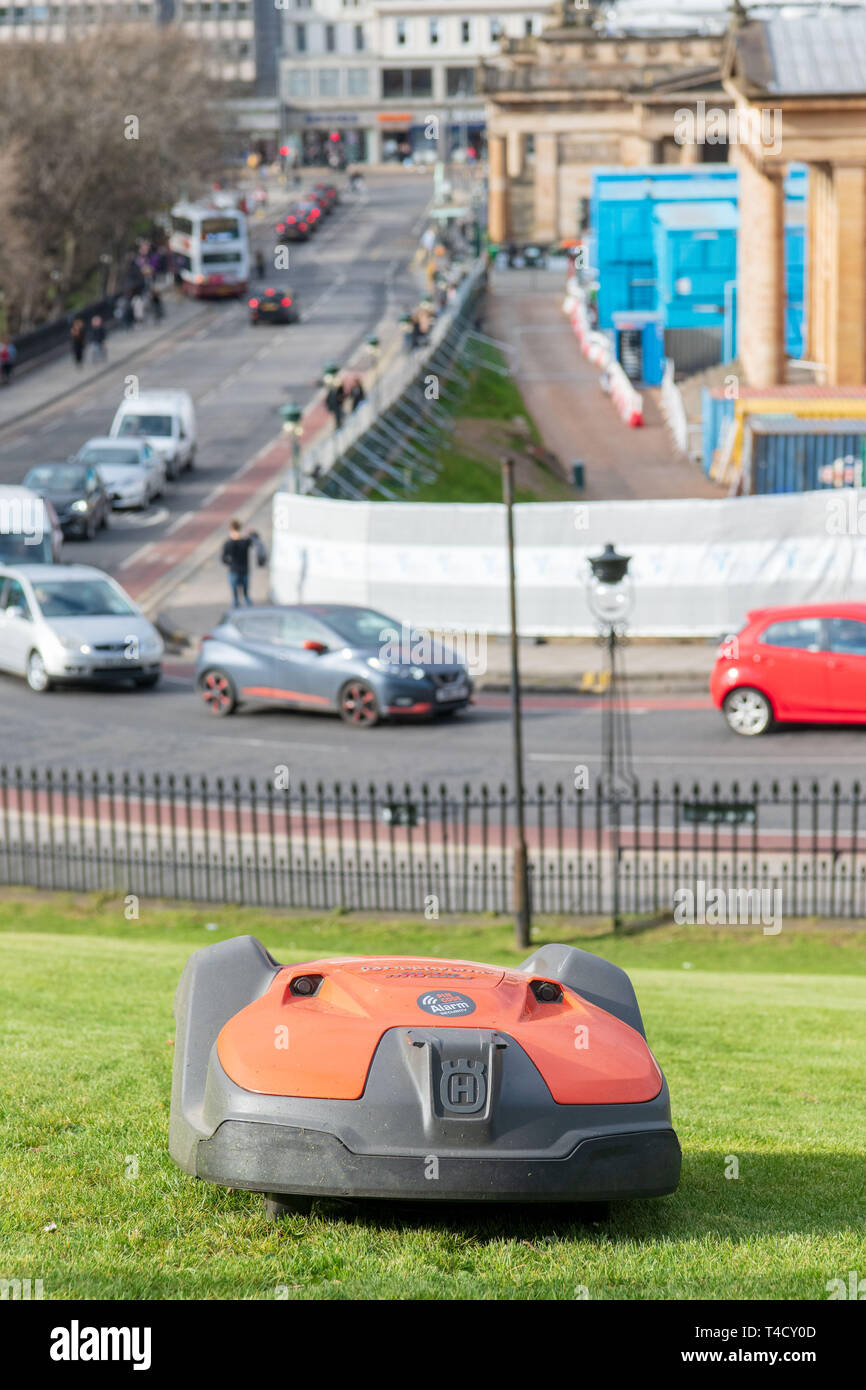 A Robotic automated lawnmower cuts the grass on the mound Stock Photo