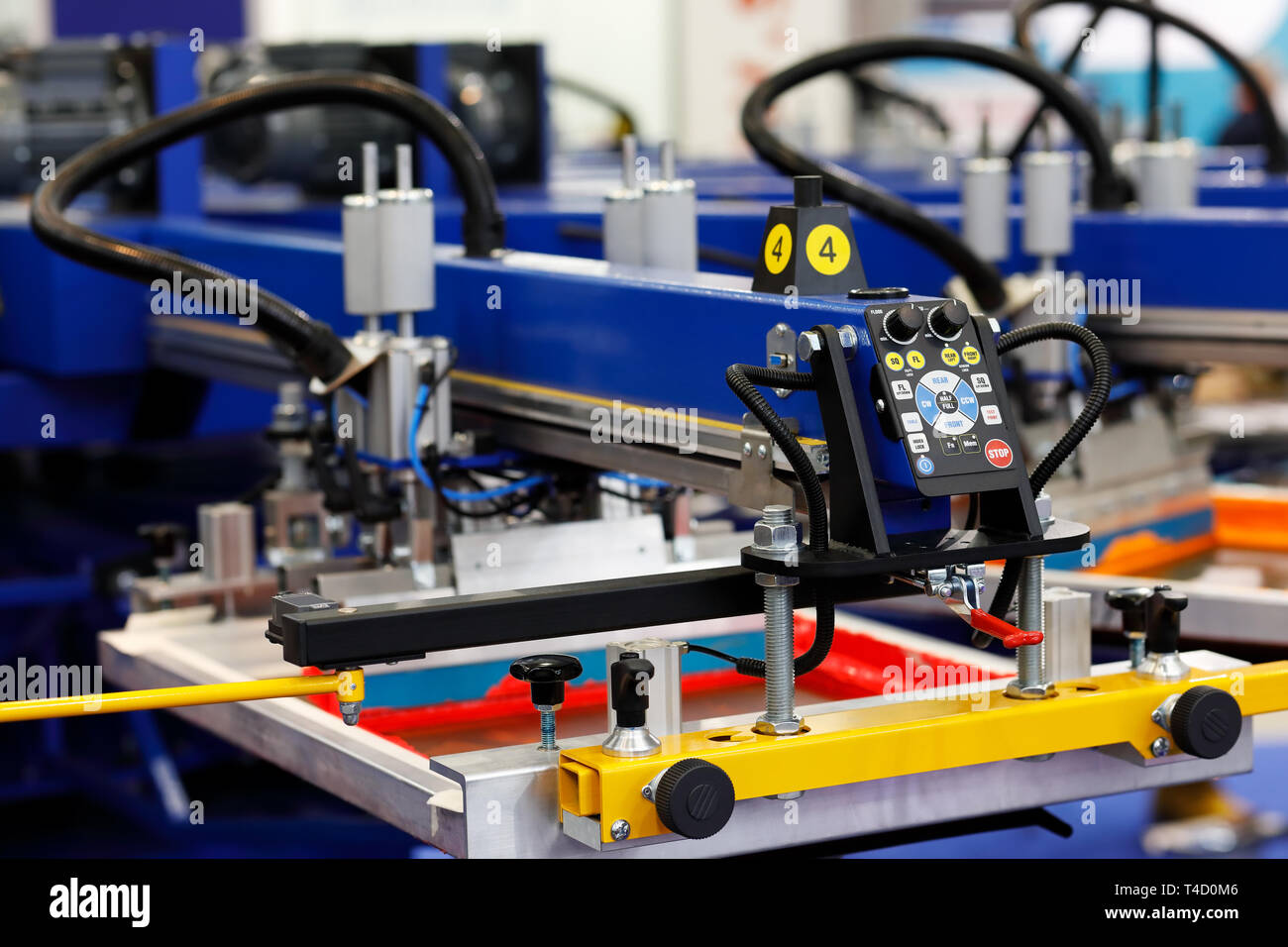 Automatic t-shirt screen printing rotary machine. Selective focus. Stock Photo