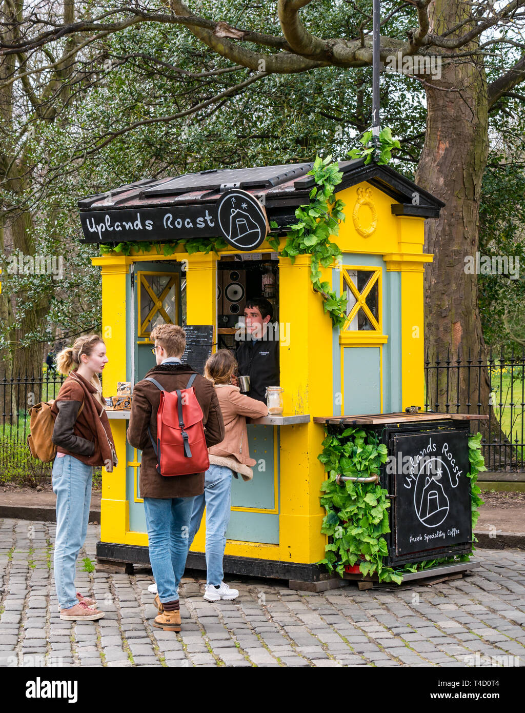 Students at takeaway coffee stall called Uplands Roast in converted police call box, George Square, Edinburgh, Scotland, UK Stock Photo