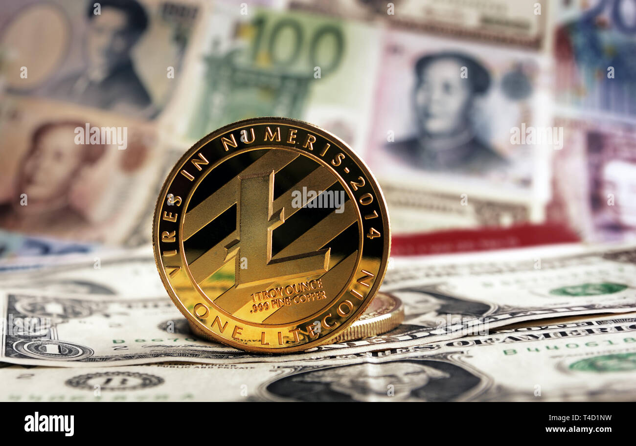 Golden Litecoin agaisnt of different banknotes on background. Cryptocurrency Trading concept Stock Photo