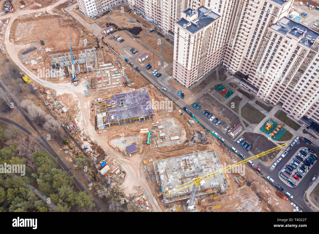 aerial top view of city construction site with yellow tower cranes ...