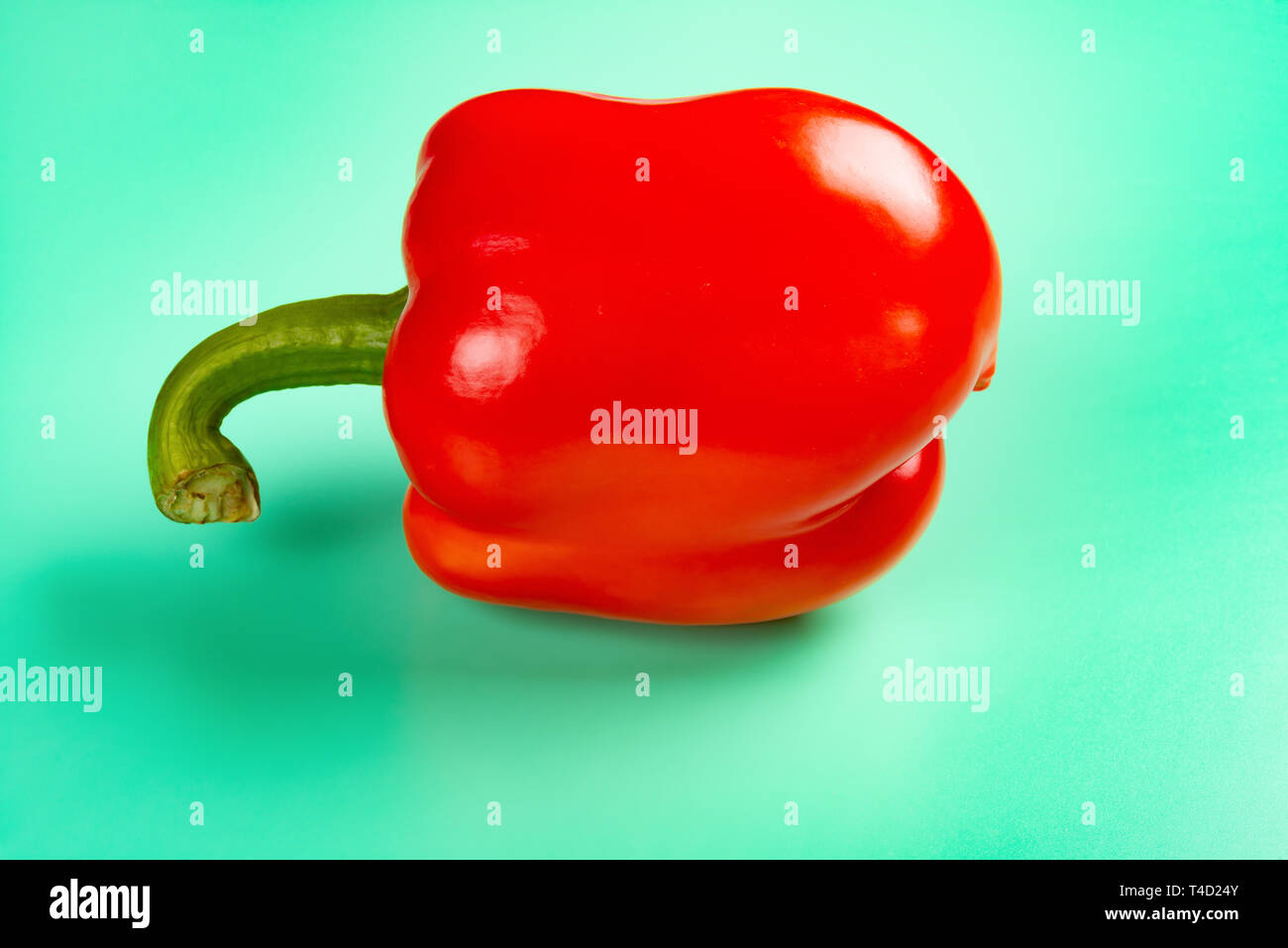 fresh red bell pepper on a light green background Stock Photo - Alamy