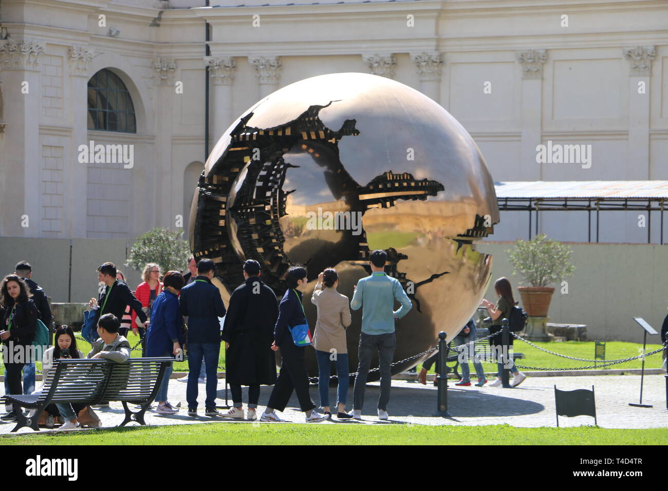 Some people looking at a strange sculpture (in the Vatican Stock Photo
