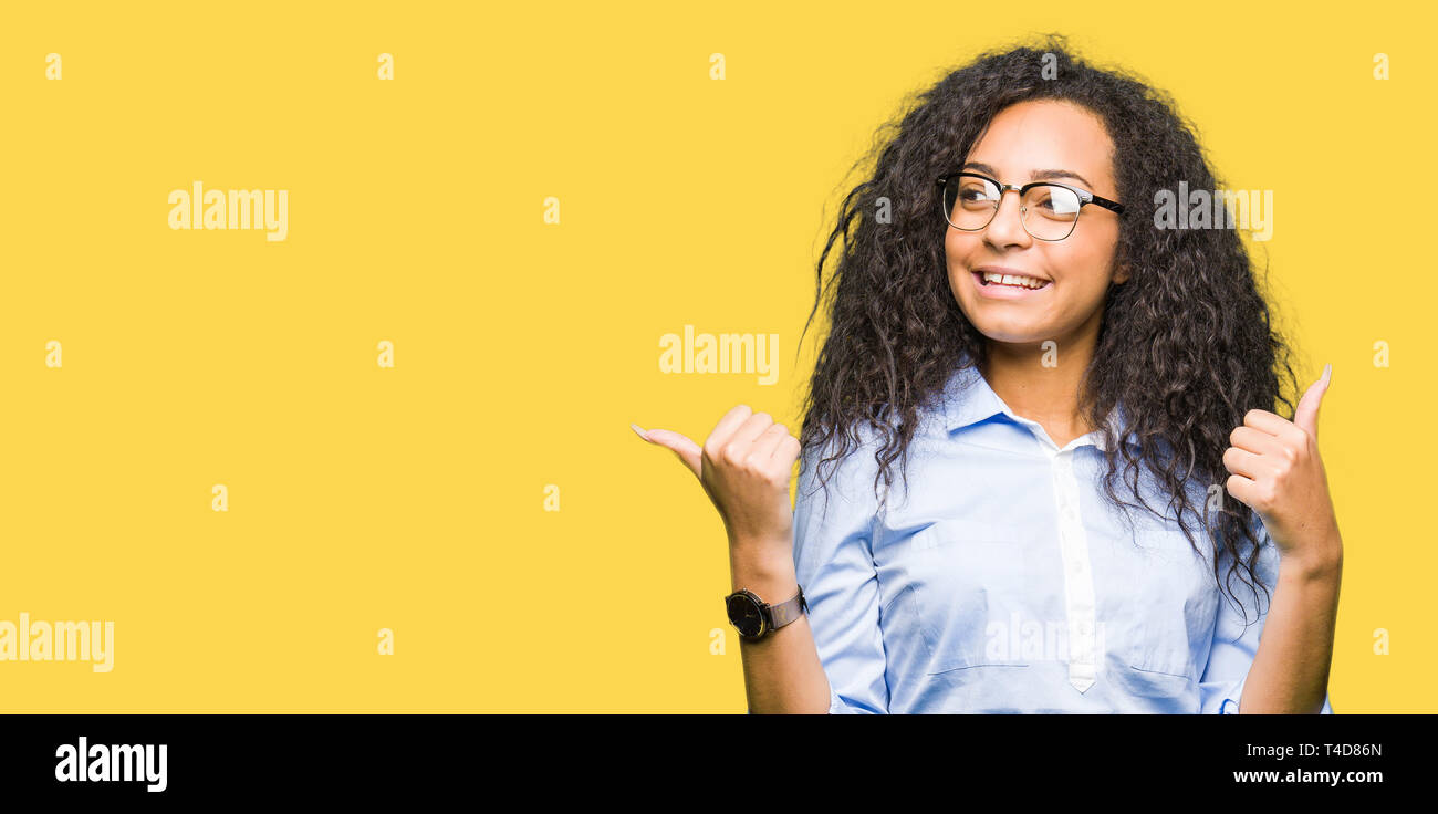 Young beautiful business girl with curly hair wearing glasses success ...
