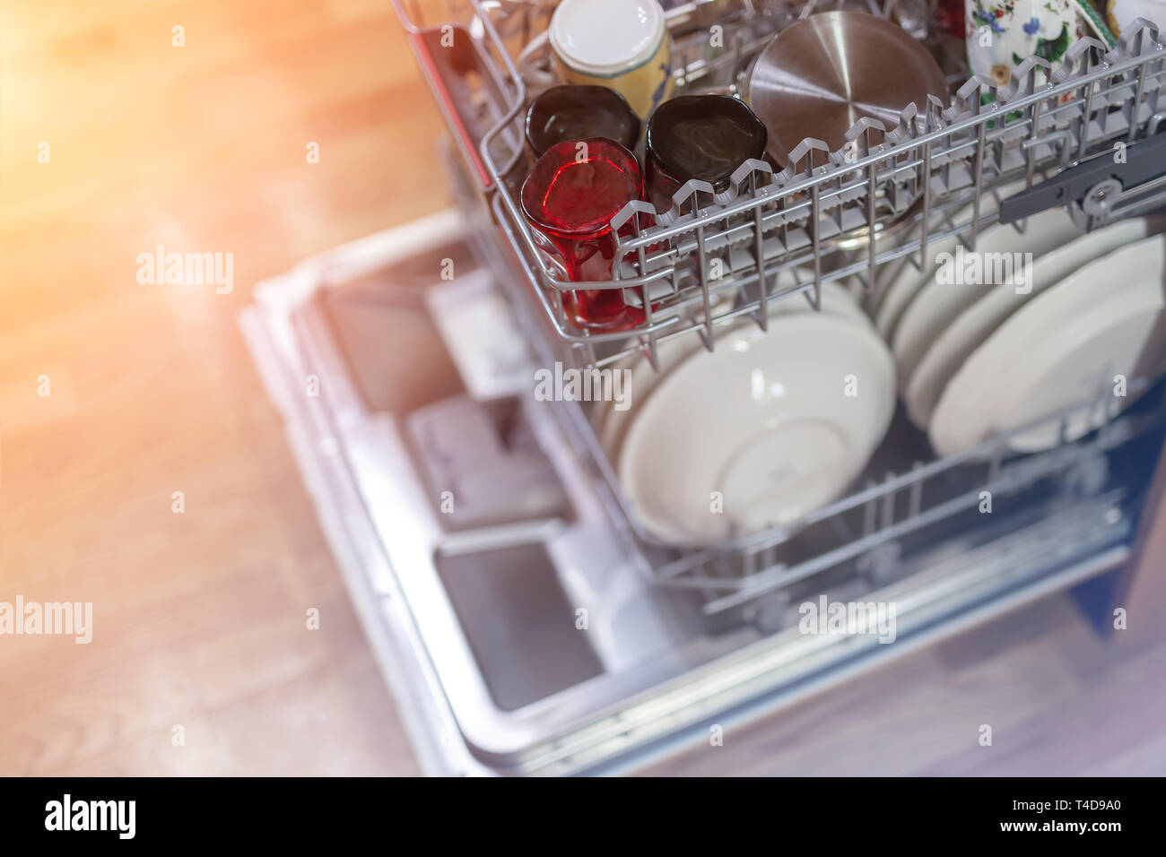 Open dishwasher machine door after cleaning process finish in wooden