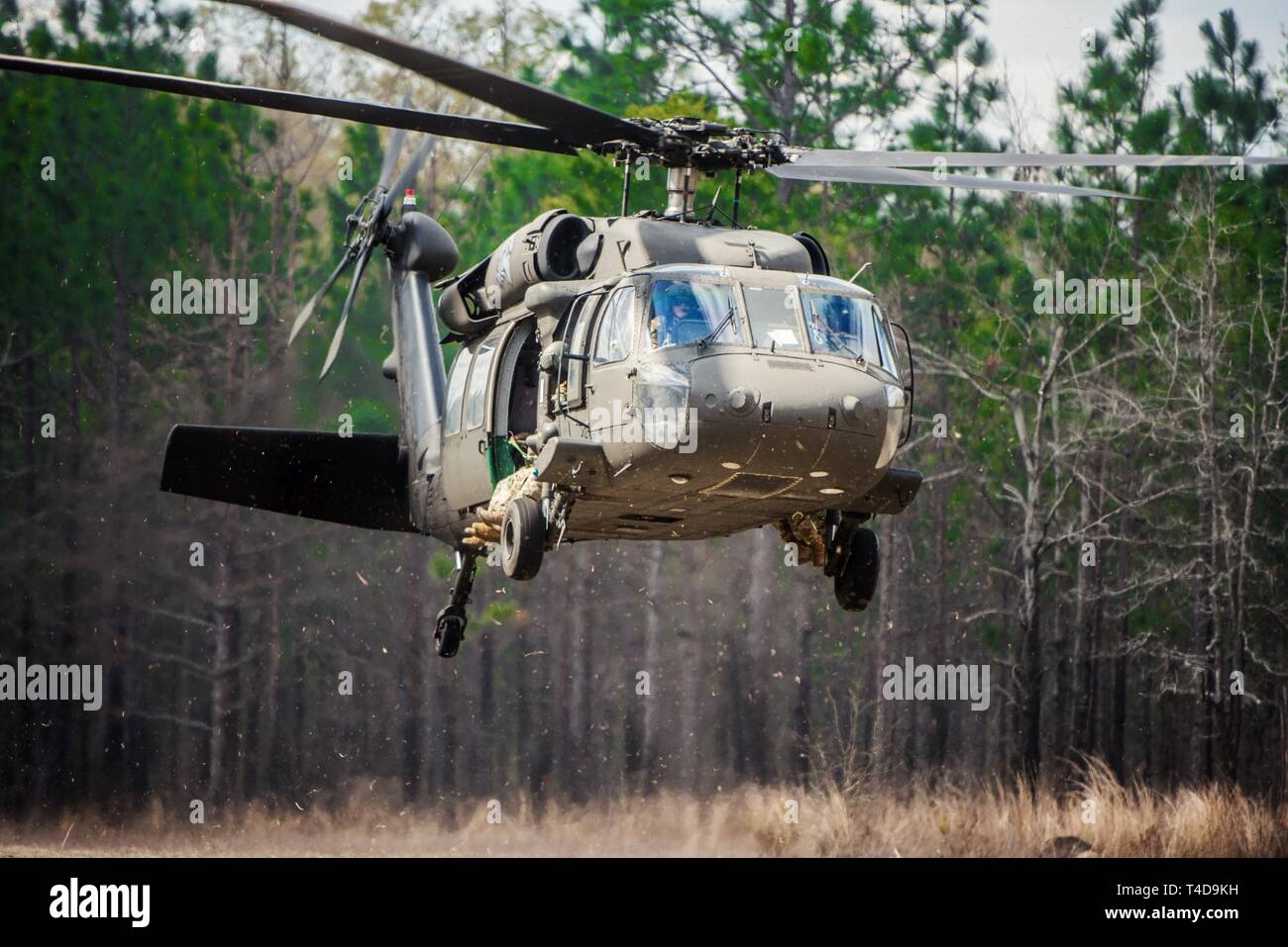 (FORT BENNING, Ga) -  Soldiers conduct pathfinder training at the Liberty Pickup Zone on post March 21, 2019.   During this portion of the training Soldiers conduct a VIRS Transmission and airborne operations from UH-60 Black Hawk helicopters.  The U.S. Army pathfinder School teaches Soldiers to infiltrate areas and set up parachute drop zones for airborne and air assault operations. Stock Photo