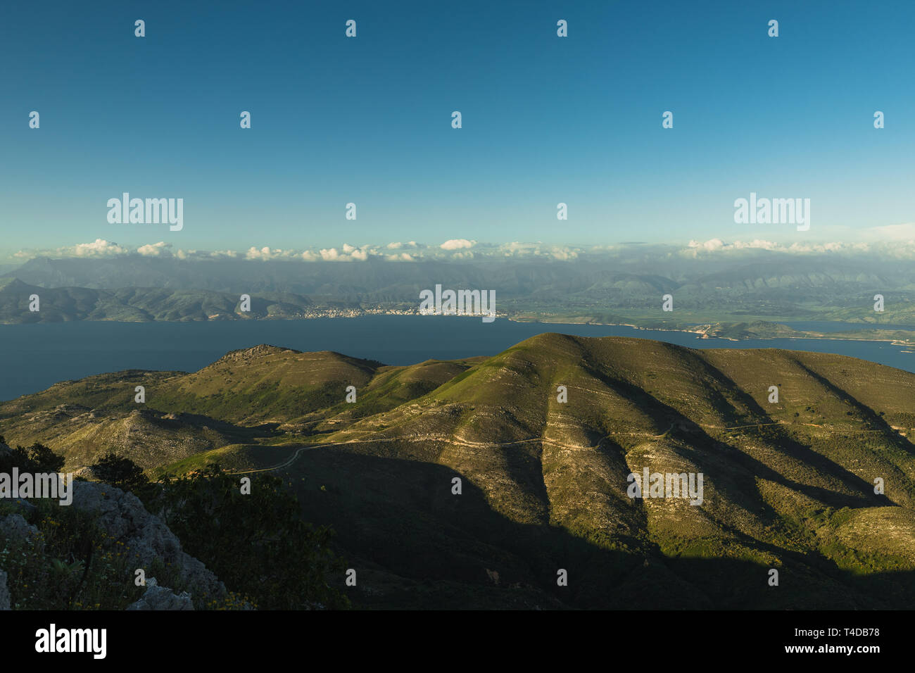 Panoramic view from the top of Mount Pantokrator, the highest mountain of Corfu with clear blue sky towards the Albanian coast (Corfu, Greece, Europe) Stock Photo
