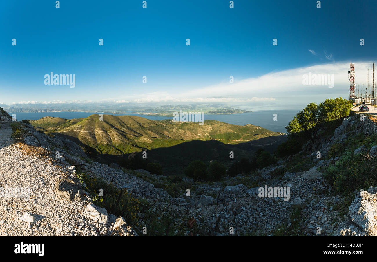 Panoramic view from the top of Mount Pantokrator, the highest mountain of Corfu with clear blue sky during evening (Corfu, Greece, Europe) Stock Photo