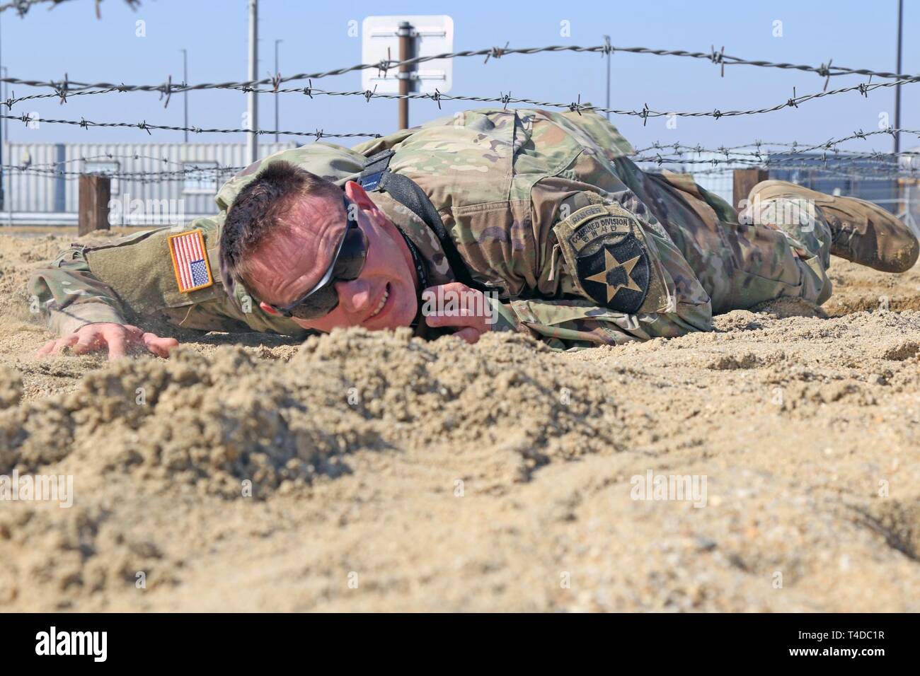 CAMP HUMPHREYS, Republic of Korea - Capt. Colby S. Miller, Phenix City, Alabama native, infantry officer, 2nd Infantry Division/ROK-U.S. Combined Division, low crawls through an obstacle course, March 22, in preparation for the 2019 Best Ranger Competition taking place at Fort Benning, Georgia April 12-14. Miller and teammate, Capt. Jonathan J. Kaminski, Atlanta, Georgia native, field artillery officer, 2nd Combat Aviation Brigade, will compete as a two-person team against more than 50 other Ranger teams. Stock Photo