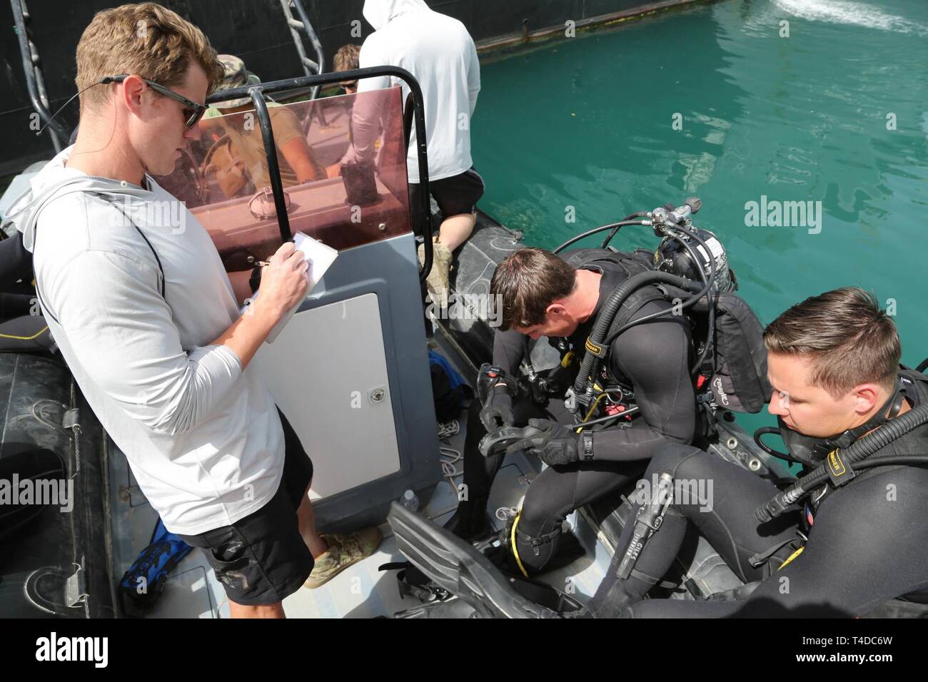 KUWAIT (March. 18, 2019) U.S. Navy Explosive Ordnance Disposal Technician 2nd Class Jacob Kawesk, conducts diving checks with fellow teammates prior to conducting Limpet mine procedures during exercise Eager Response 19. Eager Response 19 is a bilateral explosive ordnance and mine countermeasures exercise between the U.S. Navy and the Kuwait Navel Forces, allowing both nations to share knowledge and experiences to enhance mutual maritime capabilities and interoperability. Stock Photo