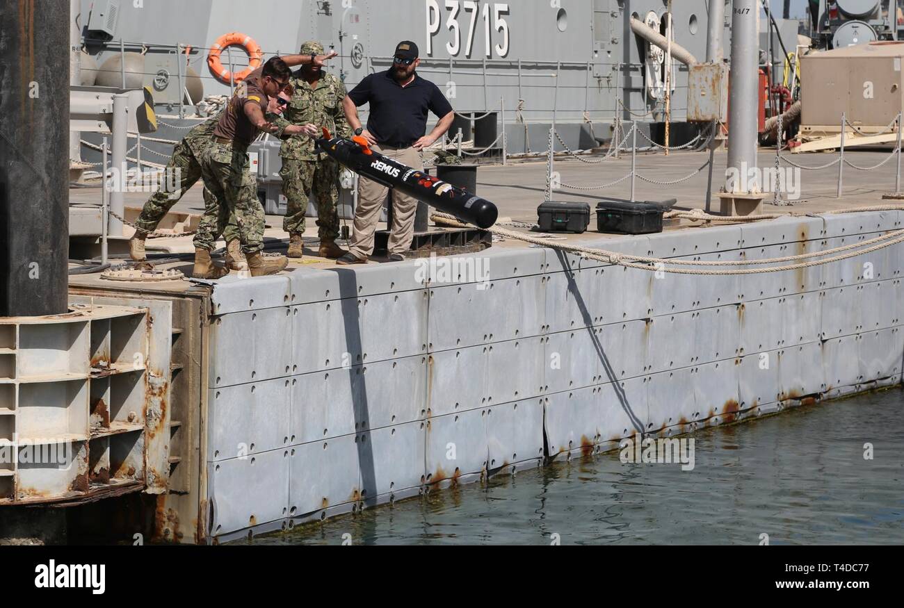 KUWAIT (March. 18, 2019) U.S. Navy Mineman 3rd Class Kody Manuel, left, and Aviation Aerographer 2nd Class Robert Wilcox launch the Remus 100, side scan sonar, for mine clearing operations during exercise Eager Response 19. Eager Response 19 is a bilateral explosive ordnance and mine countermeasures exercise between the U.S. Navy and the Kuwait Navel Forces, allowing both nations to share knowledge and experiences to enhance mutual maritime capabilities and interoperability. Stock Photo