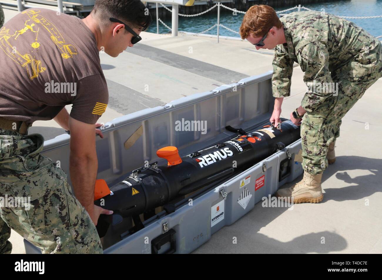 KUWAIT (March. 18, 2019) U.S. Navy Mineman 3rd Class Kody Manuel, left, and Aviation Aerographer 2nd Class Robert Wilcox prepare the Remus 100, side scan sonar, for mine clearing operations during exercise Eager Response 19. Eager Response 19 is a bilateral explosive ordnance and mine countermeasures exercise between the U.S. Navy and the Kuwait Navel Forces, allowing both nations to share knowledge and experiences to enhance mutual maritime capabilities and interoperability. Stock Photo