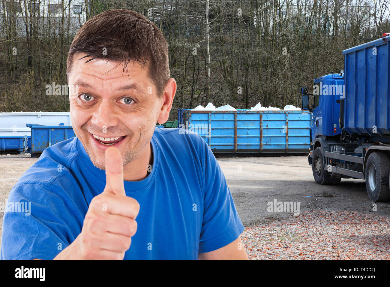 Man with thumbs up in front of a recycling-forwarding Stock Photo