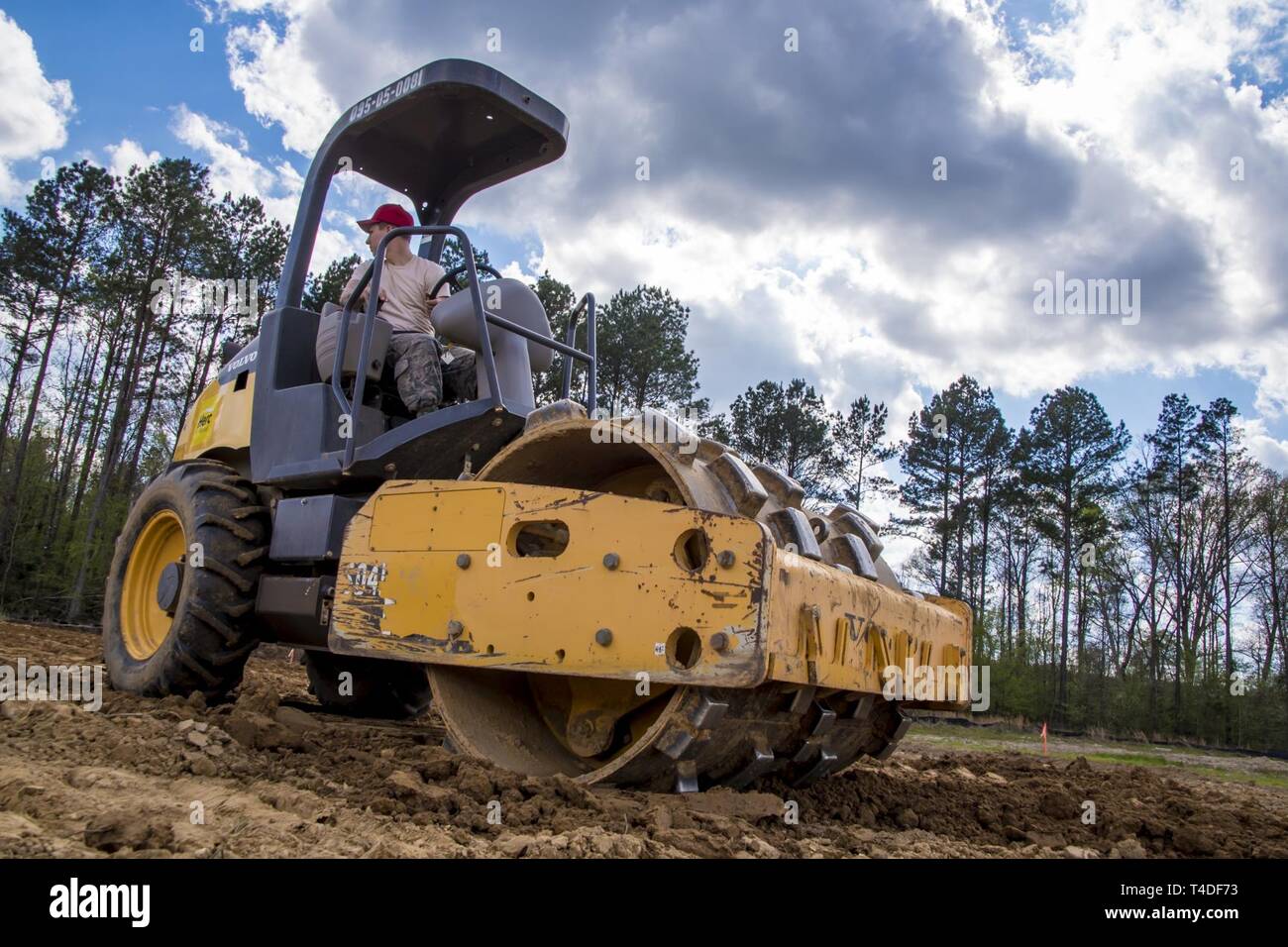 Airman First Class Cameron Filibeck operates a padfoot drum roller Mar. 25, 2019, while working with the Ohio Air National Guard, 200th RED HORSE Squadron, deployed for an Innovation Readiness Training project at Camp Kamassa, Crystal Springs, MS., helping to build a specialized camp for children with special needs. IRT projects support the community while providing valuable training for the RED HORSE mission to provide a dedicated, mobile, flexible, self-sufficient heavy construction engineering force for airfield, base infrastructure and special capabilities to support worldwide contingency  Stock Photo