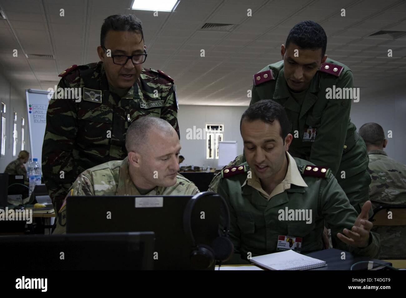 U.S. Army Soldier assigned to U.S. Army Africa and his Royal Moroccan Armed Forces counterparts discuss medical planning during exercise African Lion 2019, at the Southern Zone Headquarters in Agadir, Morocco, March 25, 2019. Participation in this multinational exercise enhances professional relationships and builds interoperability of forces. The U.S. deployed approximately 1,100 U.S. service members to join nearly 1,000 Royal Moroccan Armed Forces, approximately 250 Tunisian Armed Forces, and armed forces participants in from Canada, France, Senegal, Spain, and the United Kingdom Stock Photo