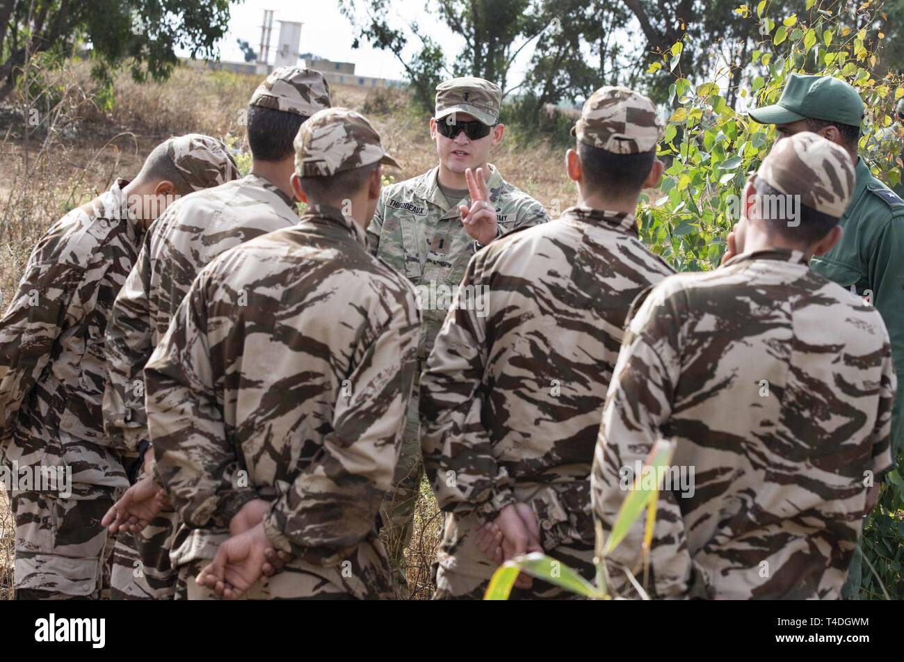 U.S. Army 1st Lt. Henry Thibodeaux with 1st Squadron, 75th Cavalry Regiment, 2nd Brigade Combat Team, 101st Airborne Division, reviews reconnaissance techniques with Moroccan special operations forces’ 2nd Airborne Brigade members during the field training exercise portion of exercise African Lion 2019 in Tifnit, Morocco, March 26, 2019. African Lion 2019 is an annual, combined multilateral exercise designed to improve interoperability and mutual understanding of each nations’ tactics, techniques and procedures while demonstrating the strong bond between the nations’ militaries. Stock Photo
