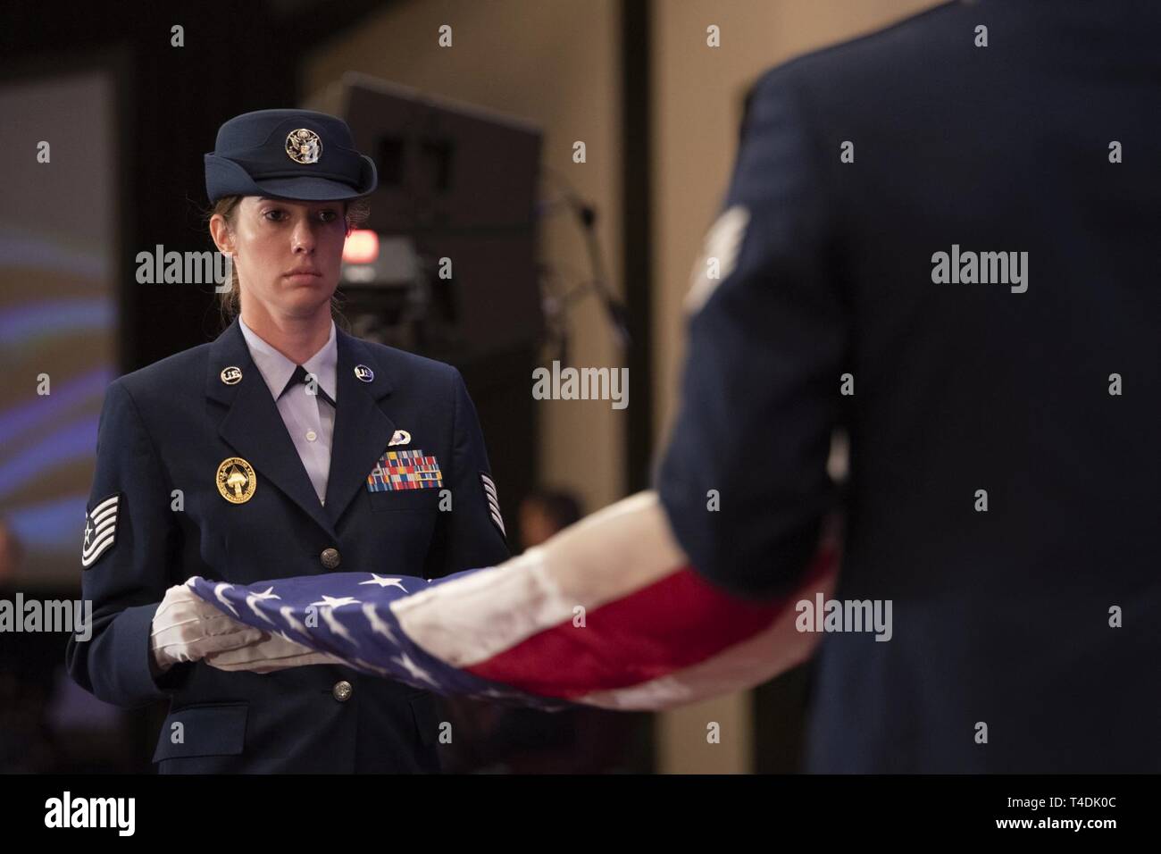 The commander of U.S. Special Operations Command, U.S. Army Gen. Raymond A. Thomas III, is presented a flag during his retirement ceremony, Tampa, Florida, March 29, 2019. Thomas retired after nearly four decades of service. Stock Photo