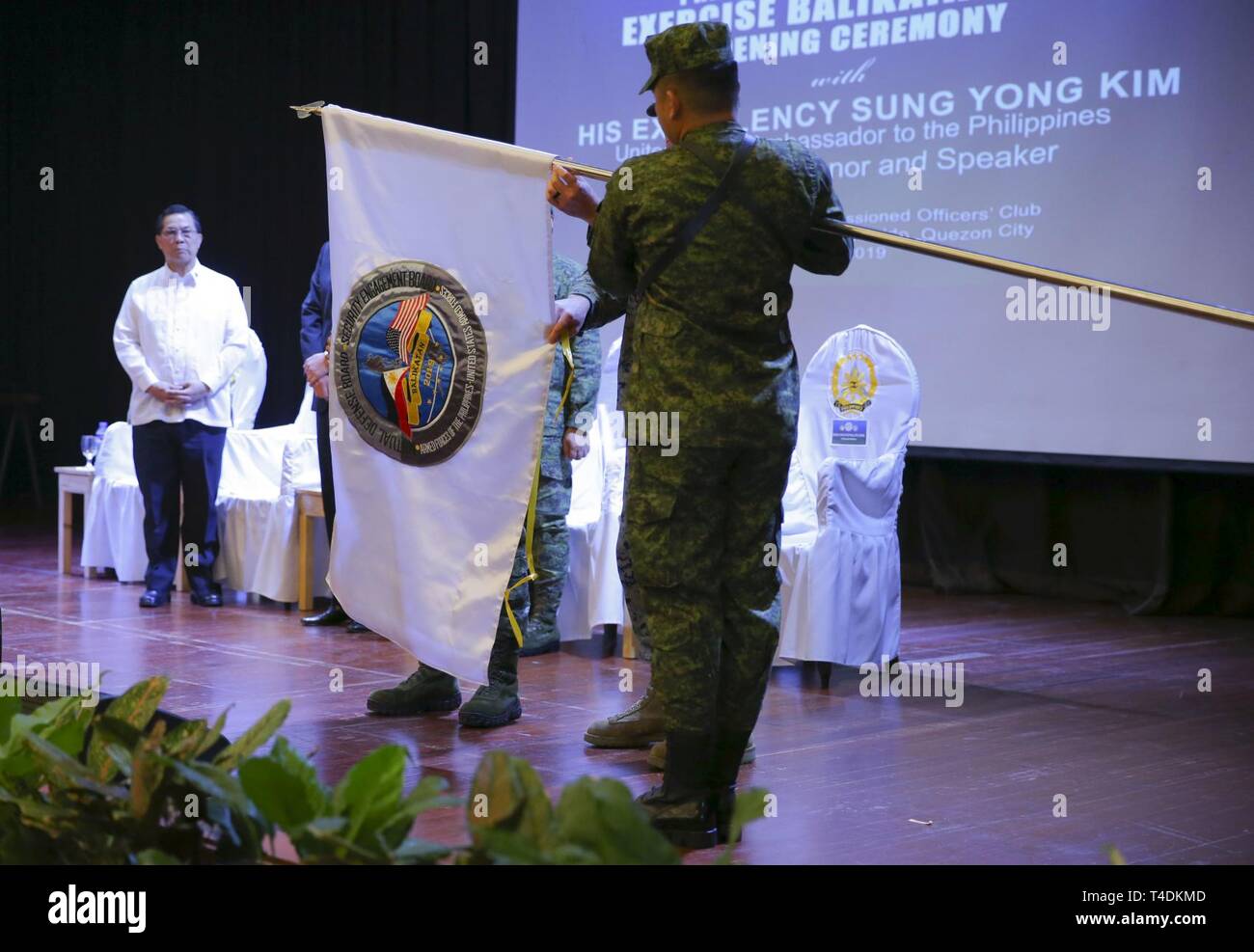 Armed Forces of the Philippines Lt. Gen. Gilbert Gapay and U.S. Marine Brig. Gen. Christopher A. McPhillips, Philippine and U.S. exercise co-directors respectively, unfurl the Balikatan 2019 flag during the opening ceremony at Camp Aguinaldo, Quezon City, April 1, 2019. Gapay is the commanding general of Southern Luzon Command and McPhillips is the commanding general of 3rd Marine Expeditionary Brigade, III Marine Expeditionary Force. Balikatan is an annual U.S.-Philippine bilateral military exercise focused on a variety of missions including humanitarian and disaster relief, counterterrorism, Stock Photo
