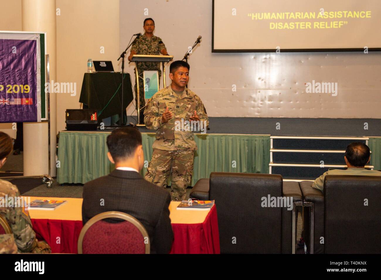 KUCHING, Malaysia (April 1, 2019) – U.S. Army Capt. Gilbert Quinto, Pacific Partnership 2019 Humanitarian Assistance and Disaster Relief (HADR) Lead, welcomes participants to a HADR conference at Sarawak State Library as part of Pacific Partnership 2019. The conference enabled civilian and military officials to discuss policies and procedures for responding to natural disasters and emergencies. Pacific Partnership, now in its 14th iteration, is the largest annual multinational humanitarian assistance and disaster relief preparedness mission conducted in the Indo-Pacific. Each year the mission  Stock Photo