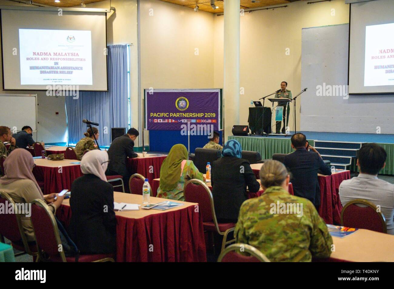 KUCHING, Malaysia (April 1, 2019) – Malaysian Army Col. Mohd Sakri Hussin, Malaysian Armed Forces senior principal assistant director, addresses the audience about roles and responsibilities during a Humanitarian Assistance and Disaster Relief conference at Sarawak State Library as part of Pacific Partnership 2019. The conference enabled civilian and military officials to discuss policies and procedures for responding to natural disasters and emergencies. Pacific Partnership, now in its 14th iteration, is the largest annual multinational humanitarian assistance and disaster relief preparedness Stock Photo