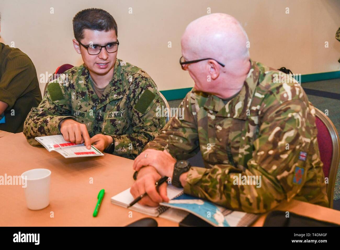 KUCHING, Malaysia (April 3, 2019) – U.S. Navy Hospital Corpsman 3rd Class Christian Plumb and Royal Air Force Flt. Lt. John Carolan-Cullion discuss disaster crisis management contingencies during a Humanitarian Assistance and Disaster Relief tabletop exercise at Sarawak State Library as part of Pacific Partnership 2019. The exercise allowed civilian and military officials to discuss policies and procedures for responding to various stages of natural disasters and emergencies. Pacific Partnership, now in its 14th iteration, is the largest annual multinational humanitarian assistance and disaste Stock Photo