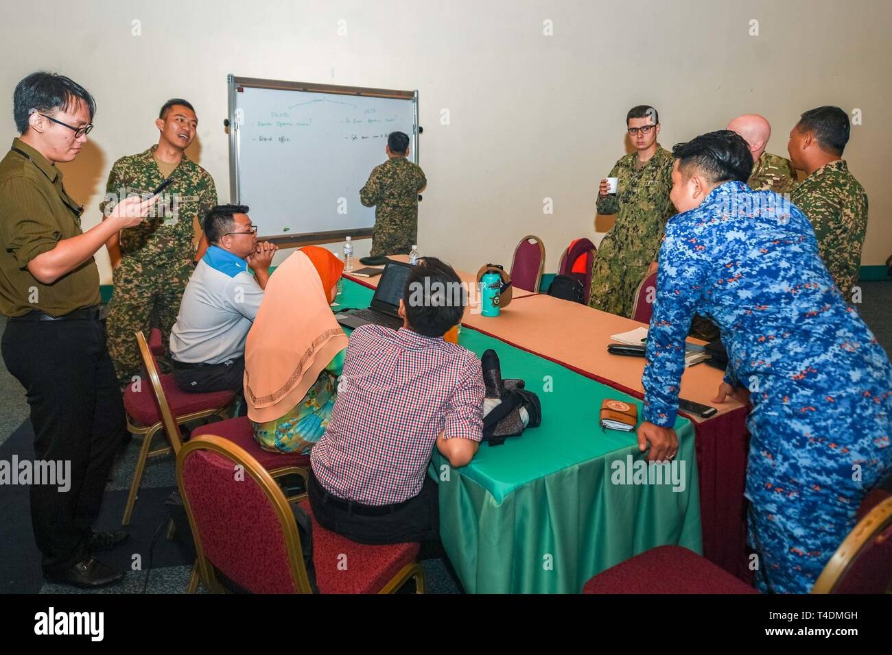 KUCHING, Malaysia (April 3, 2019) – Malaysian officials and Pacific Partnership 2019 personnel discuss disaster crisis management contingencies during a Humanitarian Assistance and Disaster Relief tabletop exercise at Sarawak State Library as part of Pacific Partnership 2019. The exercise allowed civilian and military officials to discuss policies and procedures for responding to various stages of natural disasters and emergencies. Pacific Partnership, now in its 14th iteration, is the largest annual multinational humanitarian assistance and disaster relief preparedness mission conducted in th Stock Photo