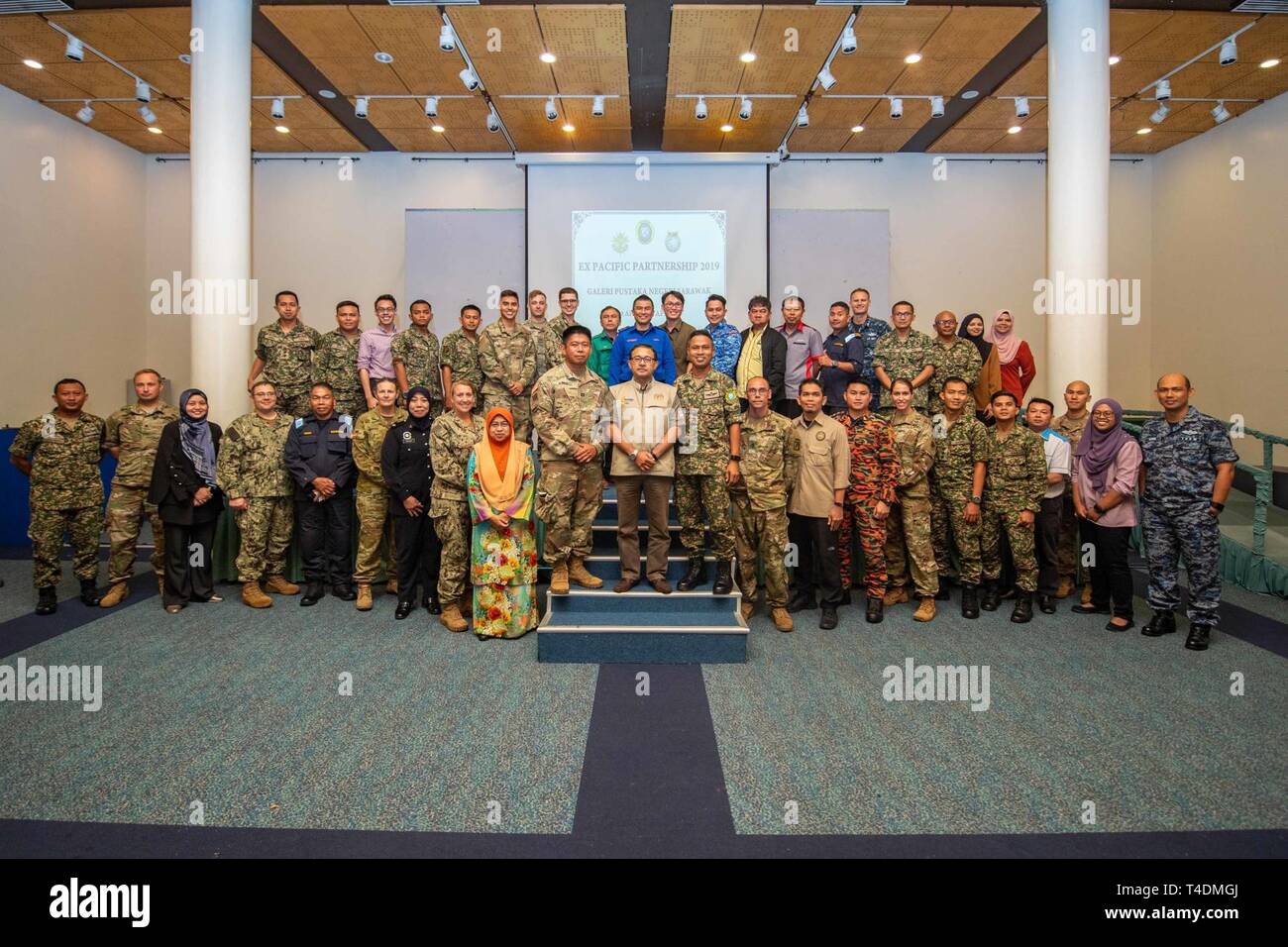 KUCHING, Malaysia (April 3, 2019) – Malaysian officials and Pacific Partnership 2019 personnel pose for a group photo following a Humanitarian Assistance and Disaster Relief tabletop exercise at Sarawak State Library as part of Pacific Partnership 2019. The exercise allowed civilian and military officials to discuss policies and procedures for responding to various stages of natural disasters and emergencies. Pacific Partnership, now in its 14th iteration, is the largest annual multinational humanitarian assistance and disaster relief preparedness mission conducted in the Indo-Pacific. Each ye Stock Photo
