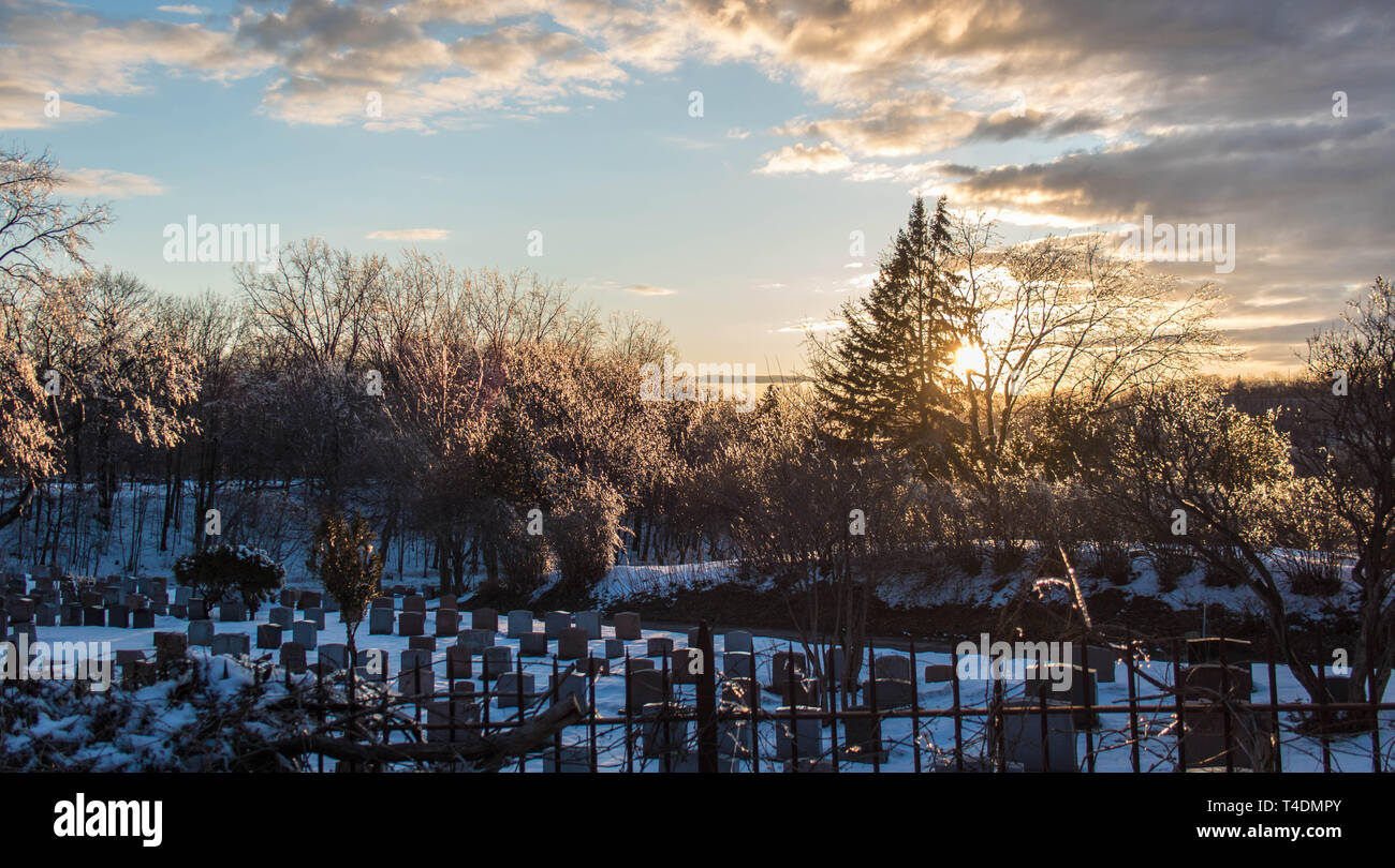 sunset on mont royal in front of the cemetery filled with snow in cold winters of montreal canada Stock Photo