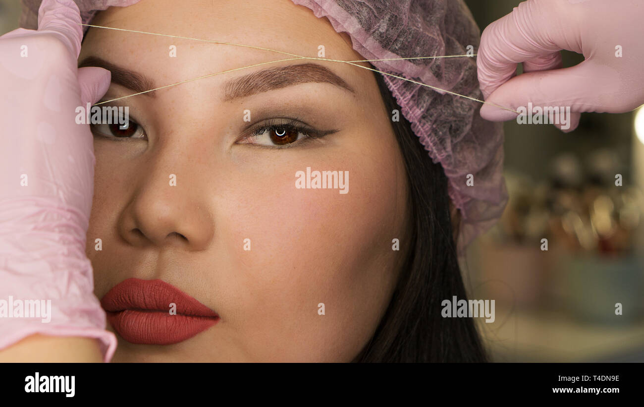 Microbleeding and eyebrow architecture. Beautician checks correctness