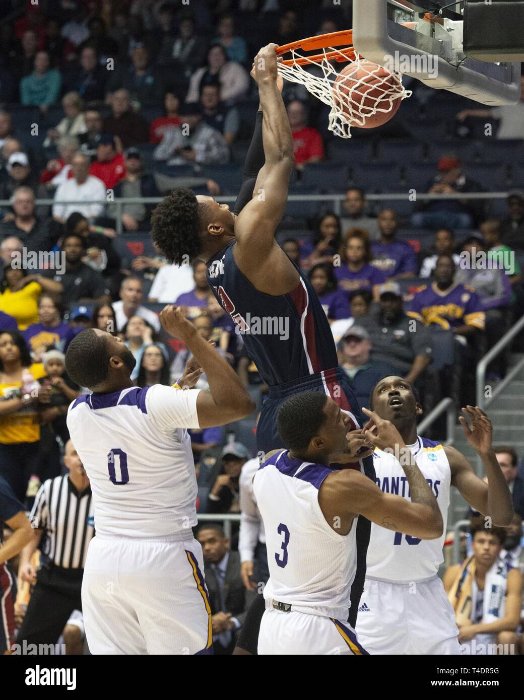 Dunks Knights A member of the Fairleigh Dickinson Knights, dunks a basketball among ...
