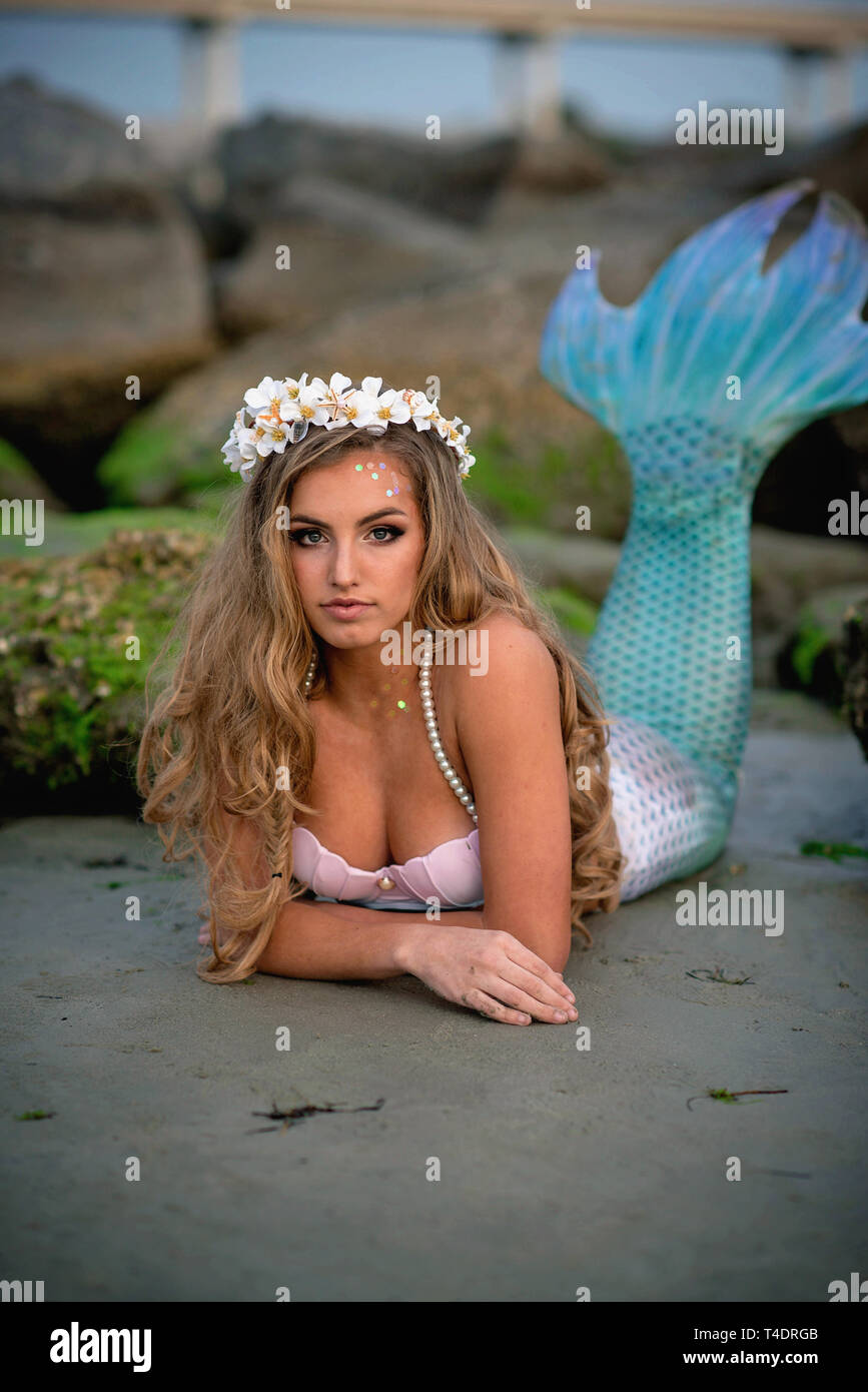 beautiful mermaid on rocky beach Stock Photo