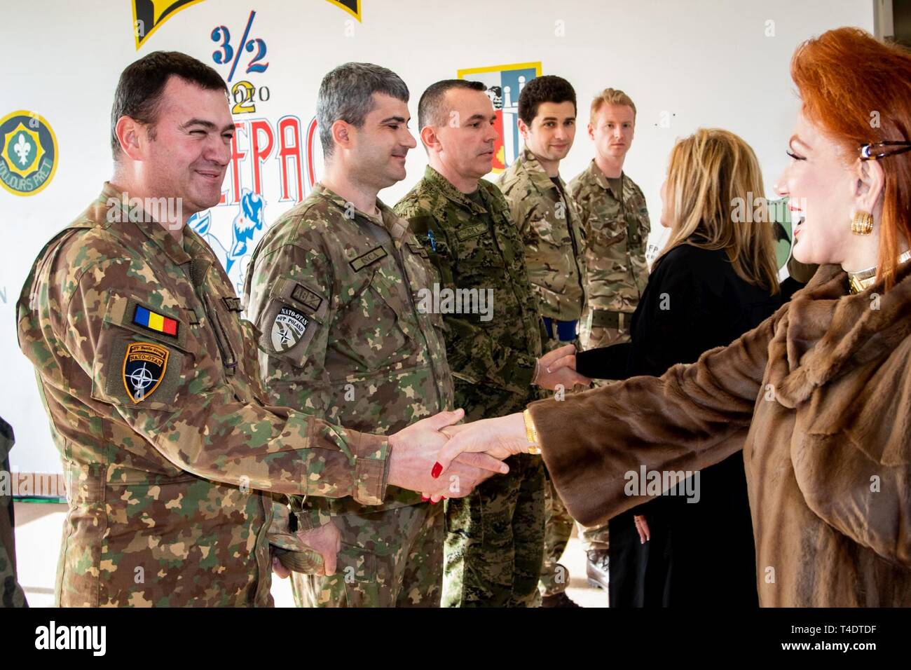 U.S. Ambassador in Poland, Georgette Mosbacher, shakes hands with Romanian Commander of the Black Bats, Maj. Julian Stoica during her visit to Bemowo Piskie Training Area in Poland with U.S. Senator Marsha Blackburn. Tennessee Army National Guard Soldiers with the 2/278th ACR are currently deployed to Poland to be the framework nation for NATO's enhanced Forward Presence Battle Group Poland. Battle Group Poland is comprised of U.S., U.K., Croatian, and Romanian Soldiers who serve with the Polish 15th Mechanized Brigade as a defense and deterrence force in northeast Poland. Stock Photo