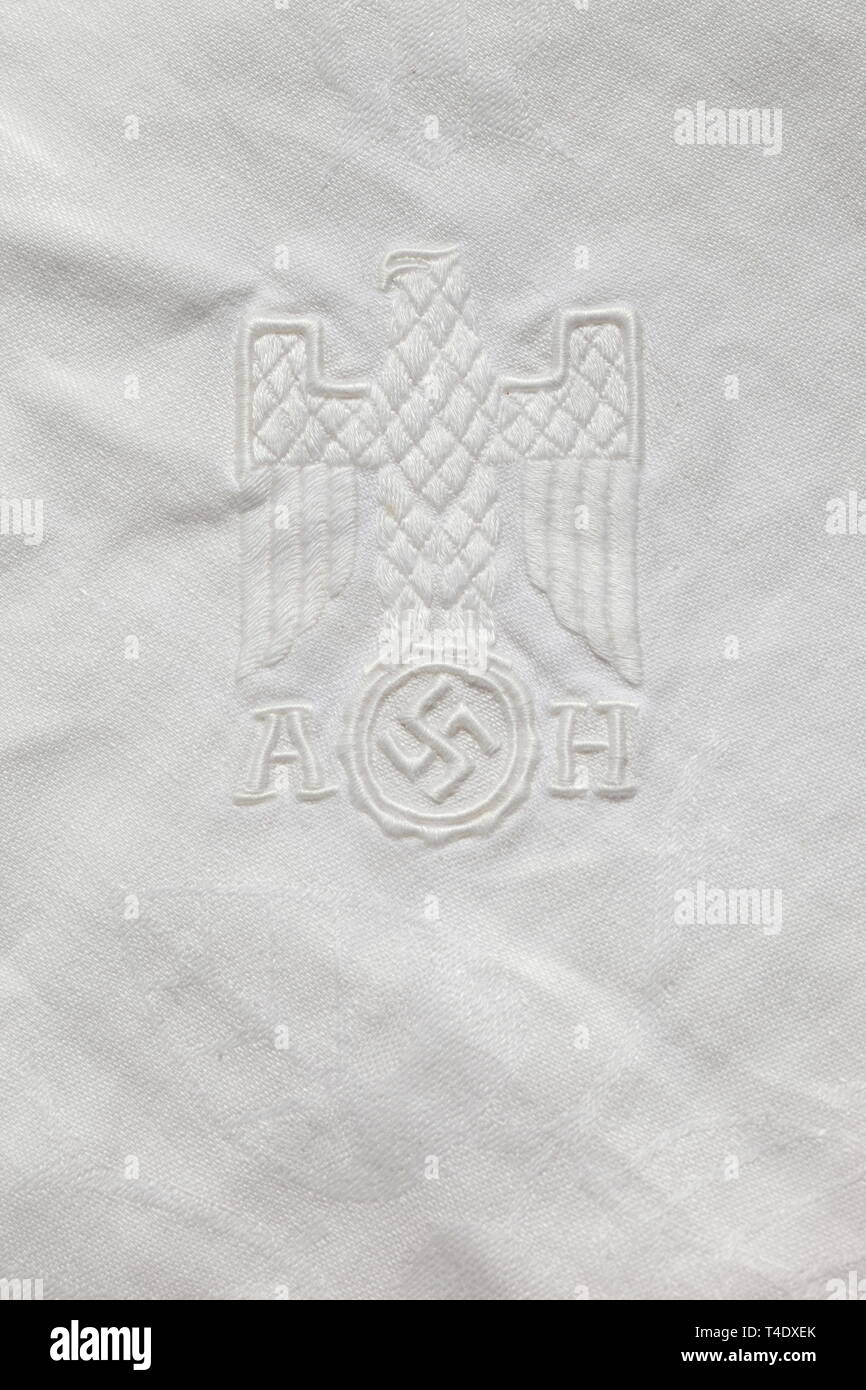 Adolf Hitler - a tablecloth and a napkin from the Kehlsteinhaus Tablecloth of white patterned linen, one corner embroidered with the national eagle in relief and monogram 'AH'. With a large napkin of the same material with identically embroidered eagle. Signs of use and age. Sizes ca. 340 x 210 cm and ca. 60 x 60 cm. historic, historical, 20th century, 1930s, NS, National Socialism, Nazism, Third Reich, German Reich, Germany, German, National Socialist, Nazi, Nazi period, fascism, Editorial-Use-Only Stock Photo