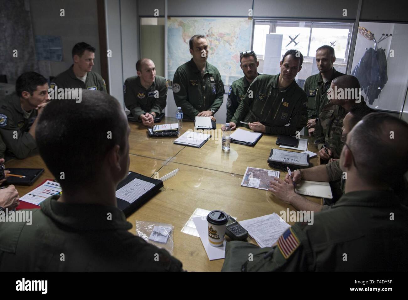 U.S. and French air force C-130J Super Hercules pilots listen as a  pre-mission briefing