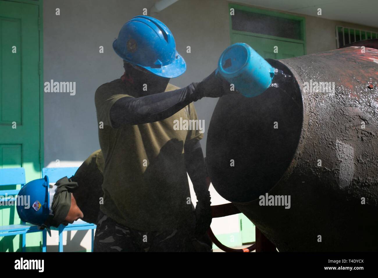 Philippine Air Force Airman 2nd Class Ricky Batuigas Pours Water Into A Mortar Mixer To Make The Correct Consistency In Pagasa Bataan Philippines As Part Of Exercise Balikatan March 25 2019 At
