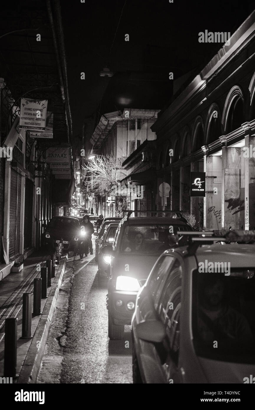 Athens, Greece - 26 Mar 2016: Traffic jam on the Athinaidos  street in central Athens near Monastiraki square with rows of cars waiting in line at night black and white Stock Photo
