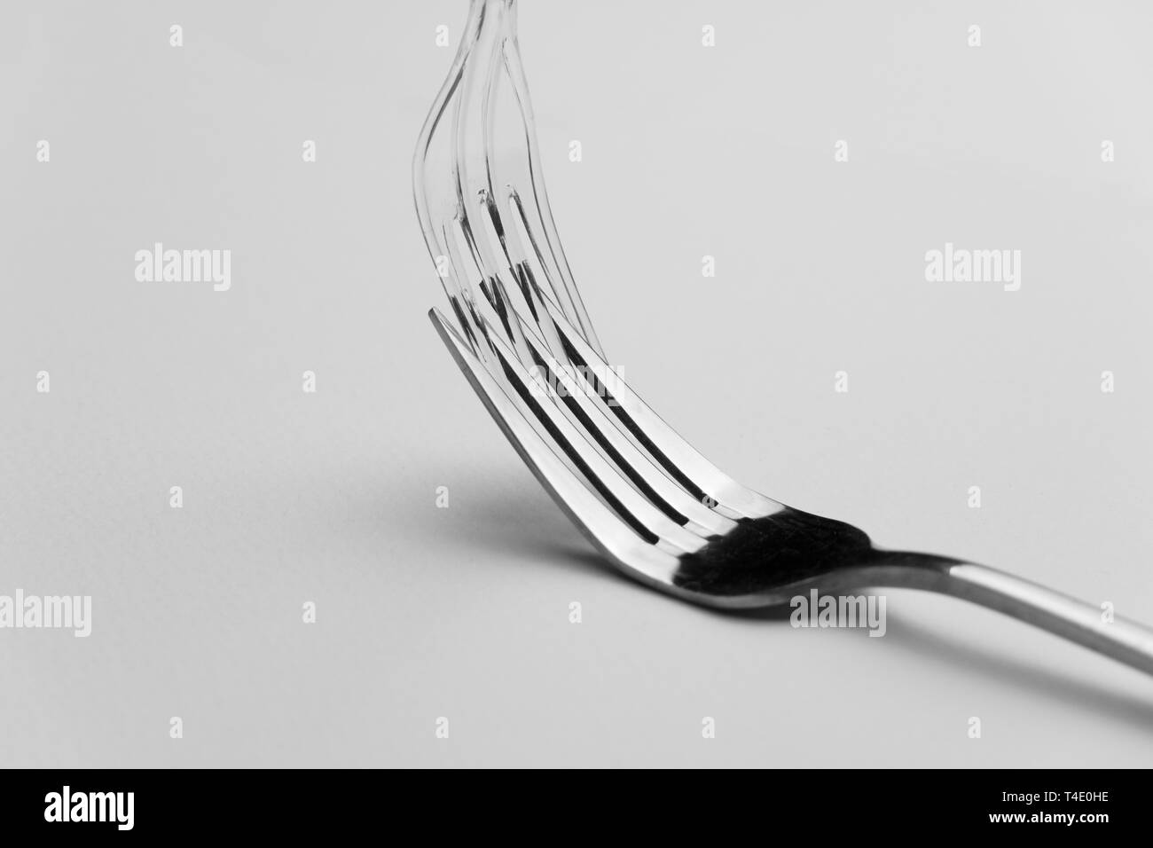 clear plastic and metal fork for food and restaurant in environmental zero waste concept background Stock Photo