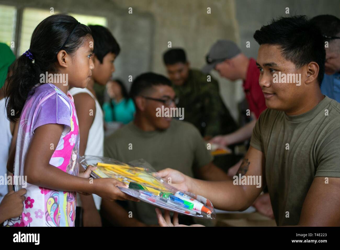 U S Army Pfc Jason Dale Gives School Supplies To A Girl As Part Of A Community Relations Event During Exercise Balikatan 19 In Pagasa Bataan Philippines March 27 19 Balikatan Is An U S Army Pfc Jason Dale Gives School Supplies To A Girl As Part Of A Community Relations Event During Exercise Balikatan 19 In Pagasa Bataan Philippines March 27 19 Balikatan Is An