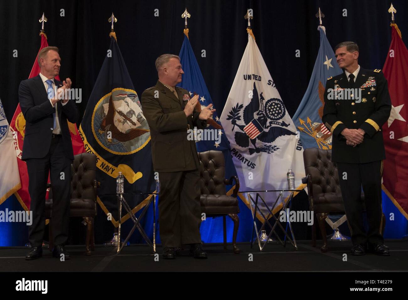 From left, U.S. Acting Secretary of Defense Patrick M. Shanahan and the new commander of U.S. Central Command, U.S. Marine Corps Gen. Kenneth F. McKenzie Jr., applaud outgoing Centcom commander, U.S. Army Gen. Joseph L. Votel, Tampa, Florida, March 28, 2018. Stock Photo