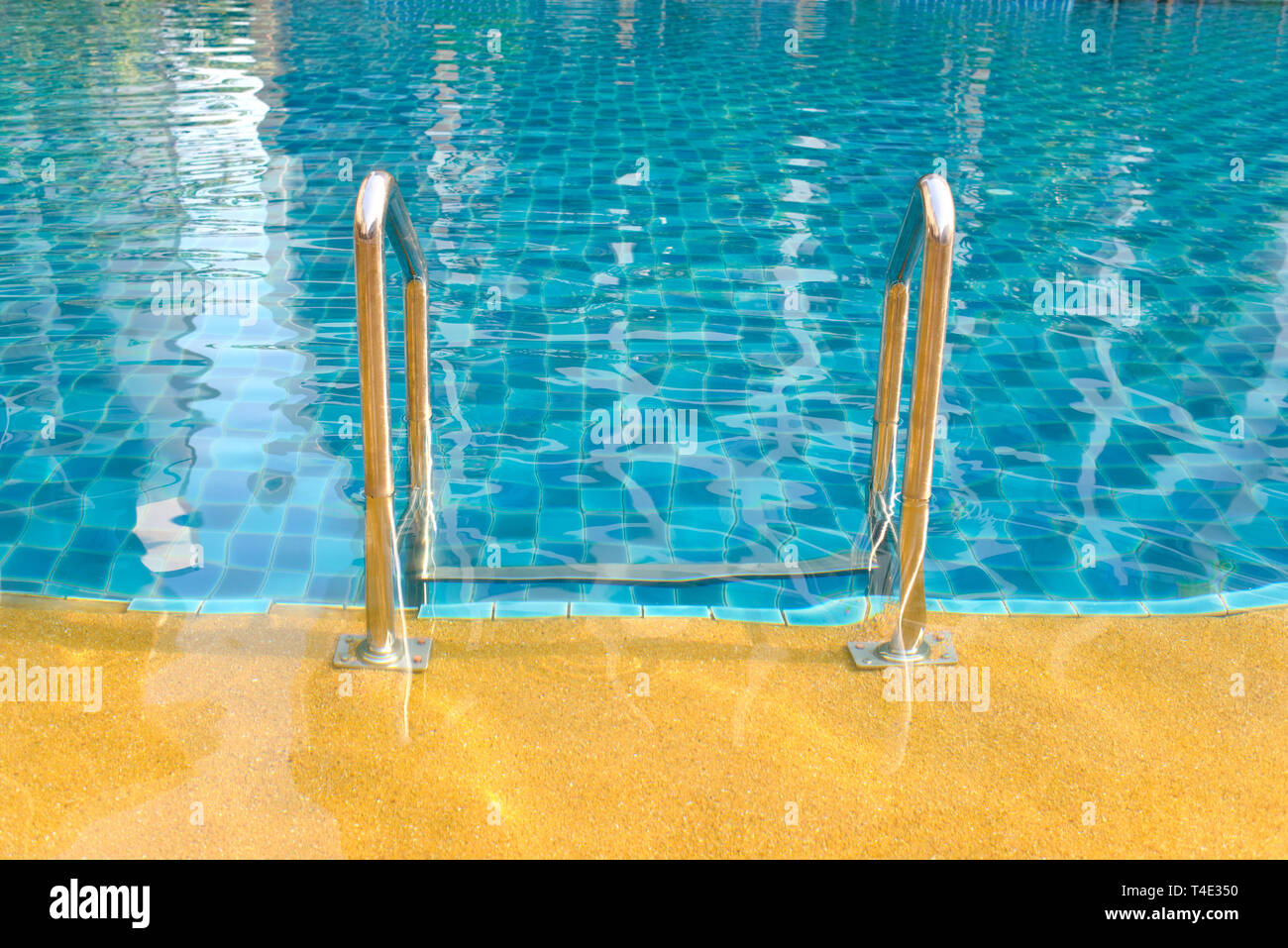 Swimming pool with grab bars ladder and stairs Stock Photo - Alamy