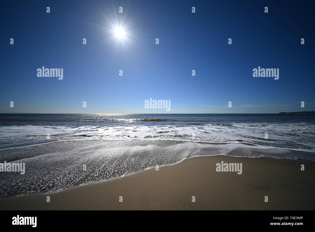 Malibu beach with the sun in the sky Stock Photo